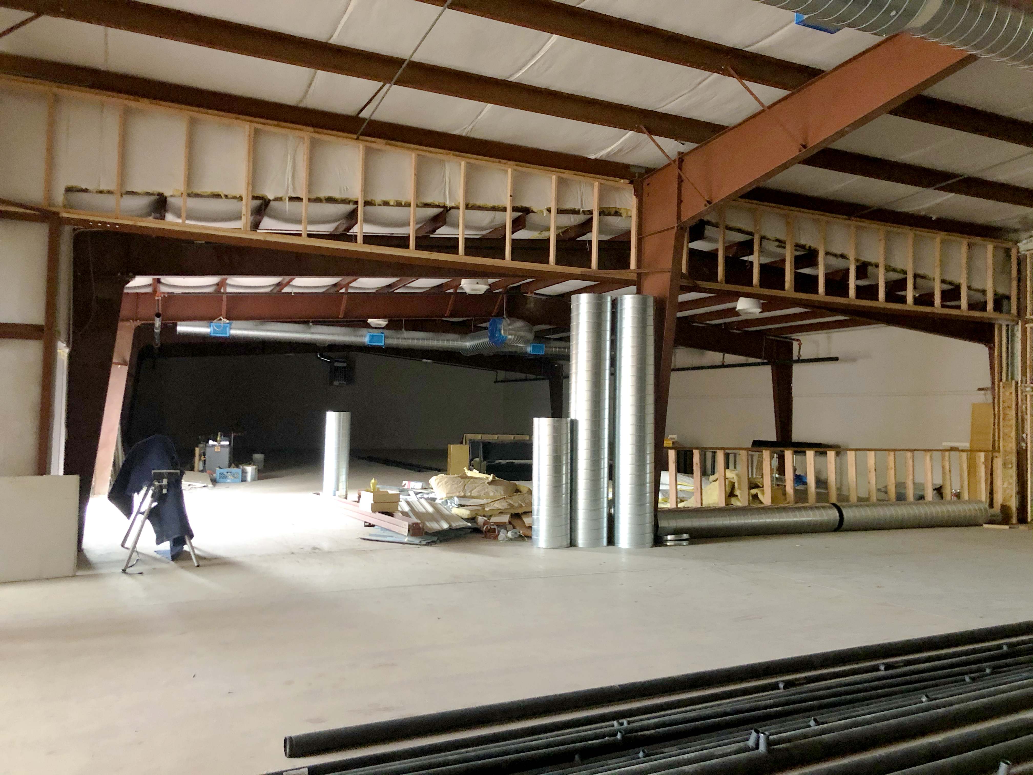 Walls, siding, and the vaulted ceilings are beginning to come together in this construction photo, separation between the center’s different activities becomes apparent